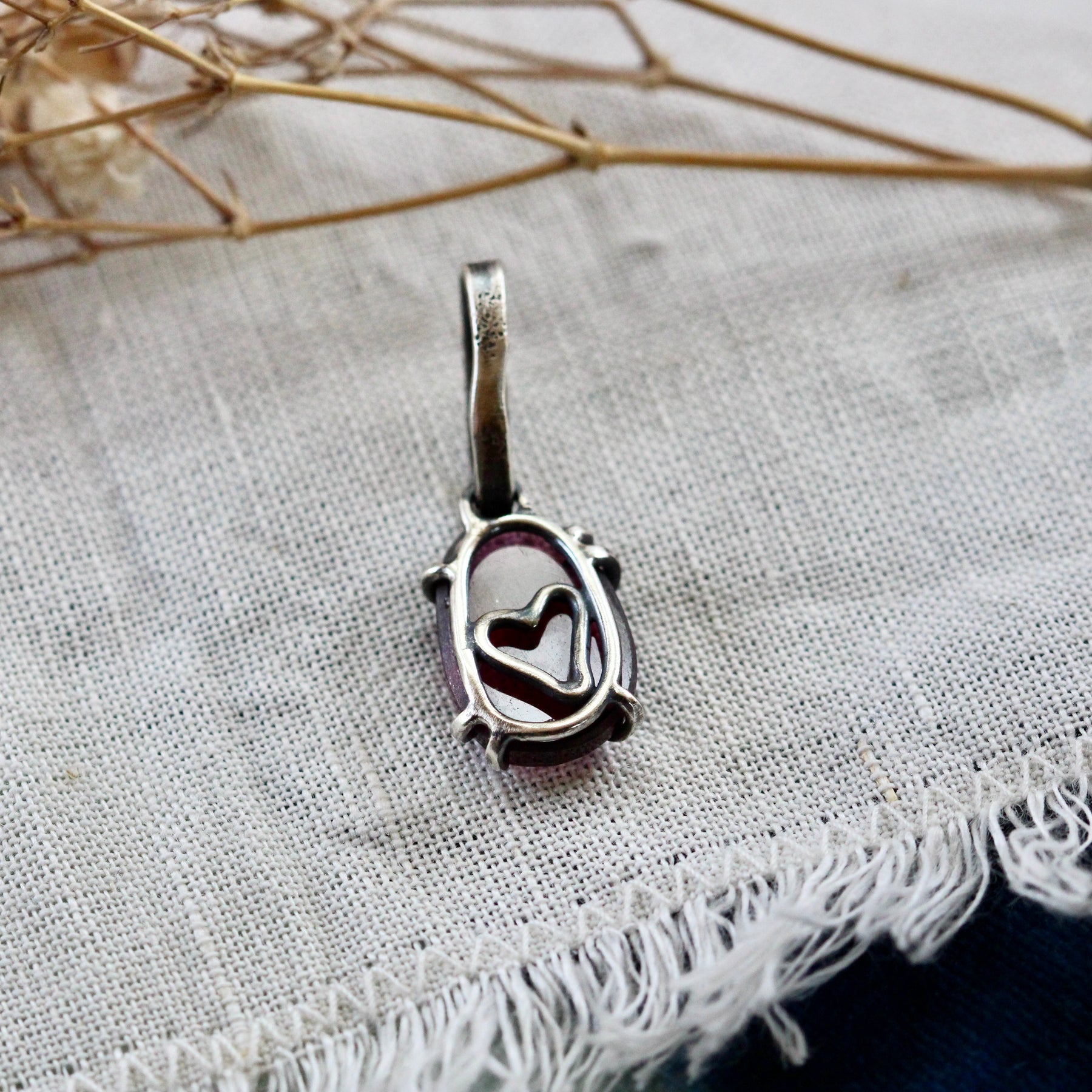 Rose cut Rhodolite Garnet prong set in sterling silver with heart deatail