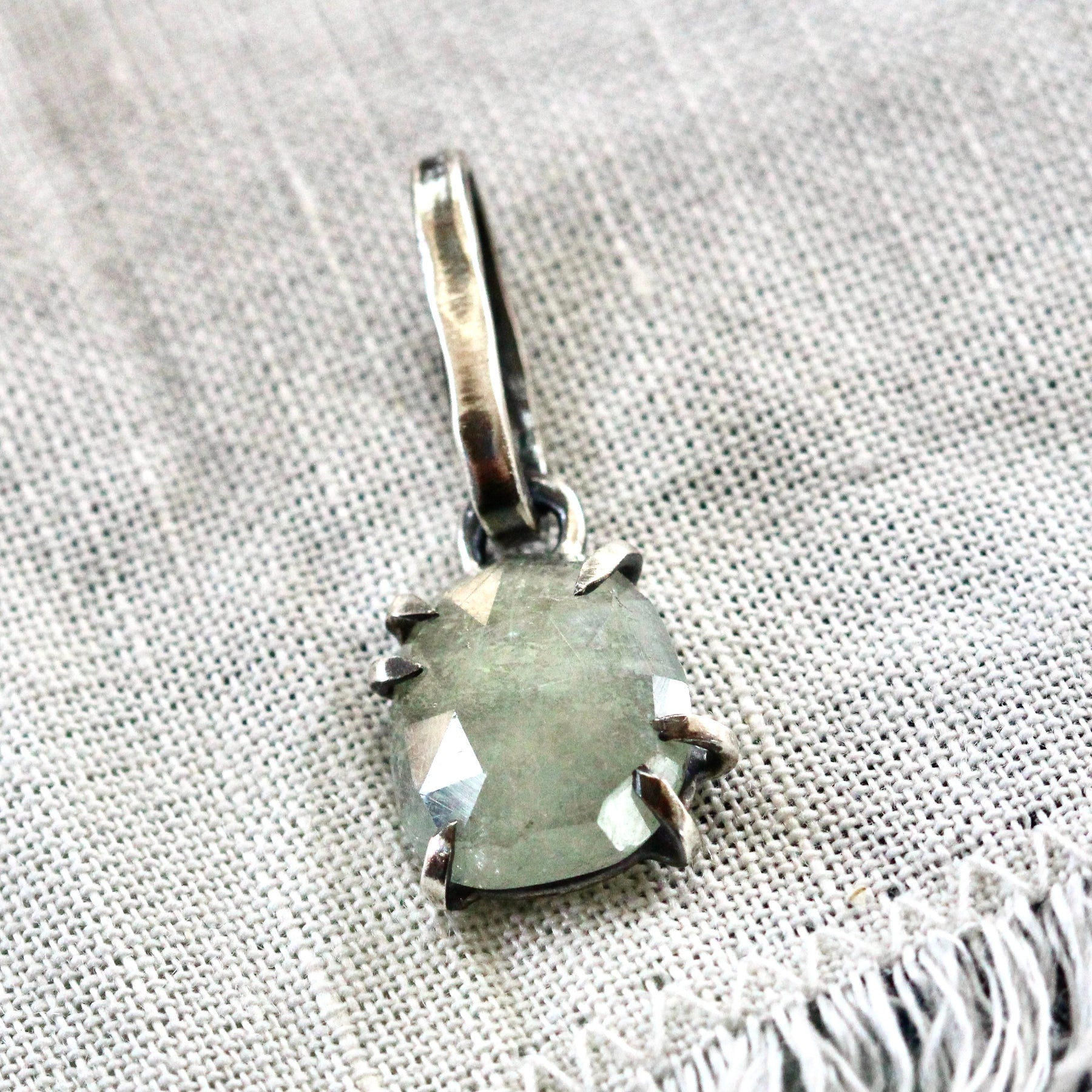 Rose cut green Sapphire prong set in sterling silver with heart detail