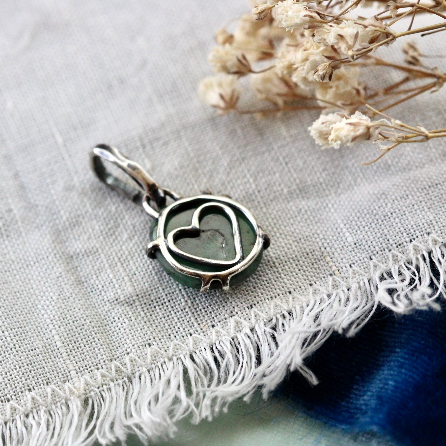 Rose cut Emerald prong set in sterling silver with heart detail