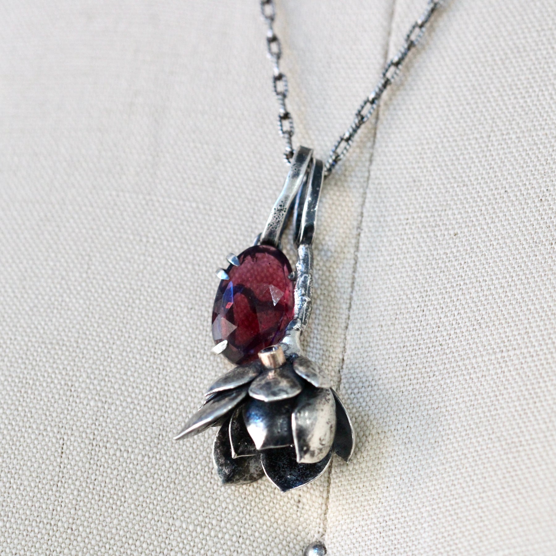 Rose cut Rhodolite Garnet prong set in sterling silver with heart deatail