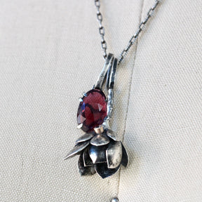 Rose cut Rhodolite Garnet prong set in sterling silver with heart deatail